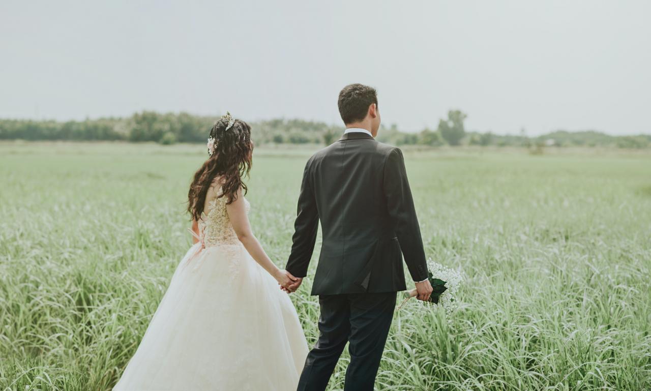 Woman in White Wedding Dress Holding Hand to Man in Black Suit ...